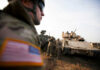 Rubio Quietly Blocked Europe Troop Cuts Soldiers in military gear coordinating near armored vehicles during training