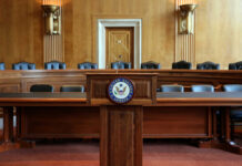 Trump’s Justice Pick Under Fire Wooden podium with the United States Senate seal in an empty Senate chamber