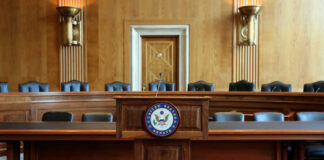 Wooden podium with the United States Senate seal in an empty Senate chamber