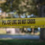 yellow police tape cordoning off an outdoor area