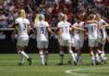 women's soccer team celebrating on the field