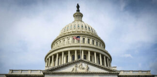 The U.S. Capitol building with an American flag flying in front