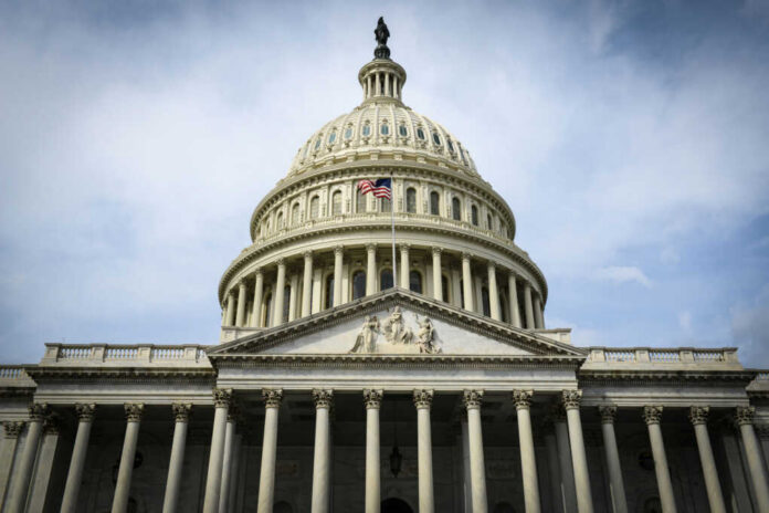 shutterstock_179079596 The U.S. Capitol building with an American flag flying in front