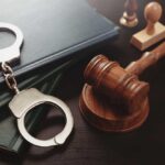 Parents Question California Sex Offender Law Handcuffs and a gavel on a desk with legal books