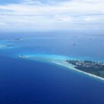 Aerial view of a tropical island surrounded by blue ocean waters