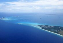 Caribbean Vacation Comes With Warning Aerial view of a tropical island surrounded by blue ocean waters