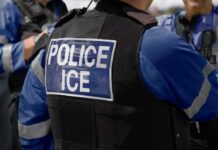 Republicans Clash Over ICE Traffic Stops Close-up of a police officer's vest with 'POLICE ICE' label