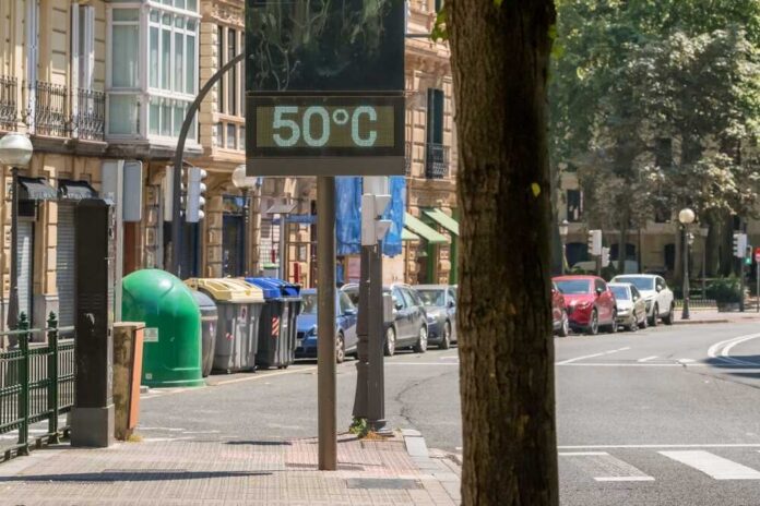 Street,Thermometer,In,Bilbao,City,Displays,Terrifying,50,Degrees,Celsius A thermometer held against a sunset city skyline