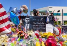 Charlie Kirk Murder Hearing Draws National Focus A memorial site with flowers, balloons, and a large photo honoring Charlie