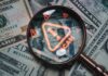 $250 Million Fraud Ends In Guilty Plea Magnifying glass over U.S. dollar bills with a scam warning