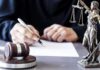Epstein-Style Deal Shadows Texas Power Judge writing at desk with gavel and Lady Justice statue
