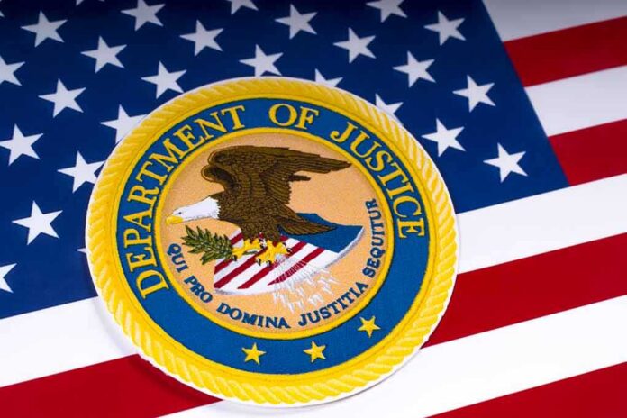 shutterstock_1054857701 Department of Justice seal on American flag background