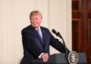 man at podium with presidential seal