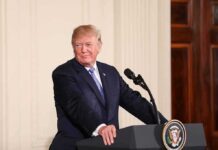 Trump’s DOJ Overhaul Sparks Independence Fight man at podium with presidential seal