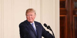 man at podium with presidential seal