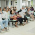 Crowd of people waiting in a hospital waiting area