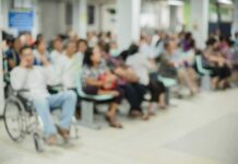 Big Pharma Strangles Rural Hospitals Crowd of people waiting in a hospital waiting area