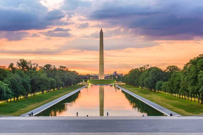 shutterstock_1140788474 Washington Monument reflected in the Lincoln Memorial Reflecting Pool at sunset