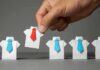 Hand picks origami shirt with red tie among blue-tied shirts