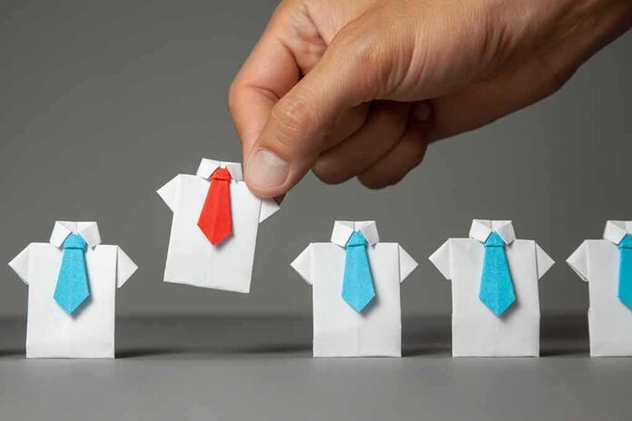 Hand picks origami shirt with red tie among blue-tied shirts