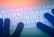 Shock Upset Brewing In Orange County? Gloved hands typing on a keyboard with highlighted election keys