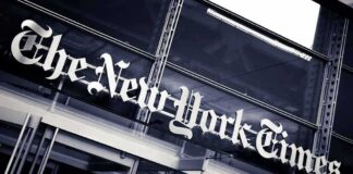 The New York Times sign on a glass building facade