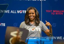 Michelle Obama Sparks Hair War woman speaking at a podium during a voting event
