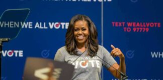 woman speaking at a podium during a voting event