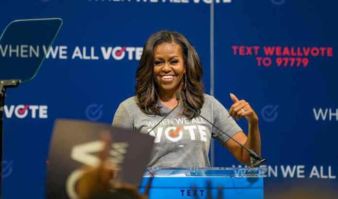 woman speaking at a podium during a voting event