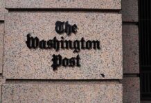 The Washington Post sign on a granite building facade