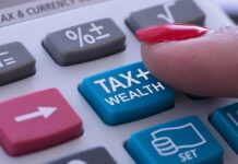 Silicon Valley Showdown Over Billionaire Tax finger pressing tax button on calculator