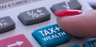 finger pressing tax button on calculator