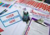Ballot Brawl Explodes Over SAVE Act Voter registration table with forms, pens, and informational materials