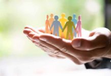 Bishop Blames Atheism For LGBT Surge Hands holding a row of colorful paper people