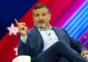 Cruz Money Bomb Targets Texas Democrat man in suit speaking on stage with colorful backdrop