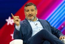 Cruz Money Bomb Targets Texas Democrat man in suit speaking on stage with colorful backdrop