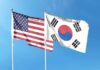 Trump Orders Major Cut To Korea Drills United States and South Korea flags waving against a clear blue sky
