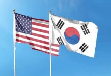 Trump Orders Major Cut To Korea Drills United States and South Korea flags waving against a clear blue sky