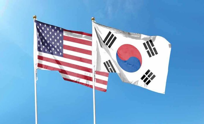 shutterstock_2294830011 United States and South Korea flags waving against a clear blue sky