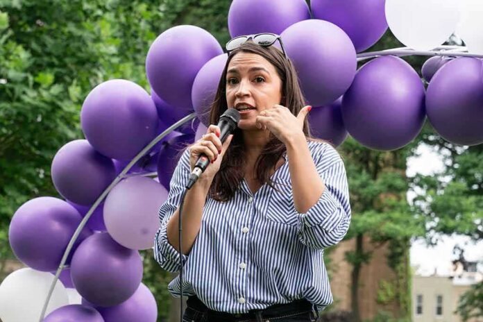 shutterstock_2328973353 Woman speaking into a microphone at an outdoor event with purple balloons