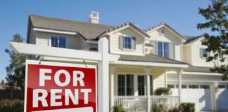 A house with a For Rent sign in the front yard