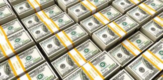 Stacks of US hundred-dollar bills bundled with yellow straps