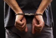 Cash Register Cover For Meth? person with hands cuffed behind back