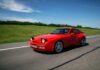 New Tire Rules Threaten Wallets Red sports car driving on a rural highway