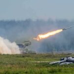 rocket launcher firing missile across a field