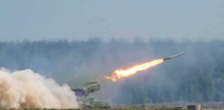rocket launcher firing missile across a field