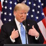 Unexpected Alliance Shocks New York Donald Trump speaking at a podium with American flags behind him