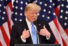 Unexpected Alliance Shocks New York Donald Trump speaking at a podium with American flags behind him