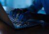 Hunter Biden Laptop Story Gets More Complicated Hands typing on a backlit laptop keyboard at night