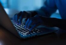 Hunter Biden Laptop Story Gets More Complicated Hands typing on a backlit laptop keyboard at night